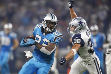 Carolina Panthers wide receiver Jerricho Cotchery (82) is tackled by Dallas Cowboys strong safety Jeff Heath (38) during the third quarter of a NFL game on Thanksgiving at AT&T Stadium. Nov 26, 2015; Arlington, TX, USA.