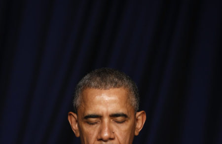 U.S. President Barack Obama bows his head in prayer as he attends the National Prayer Breakfast in Washington February 4, 2016.