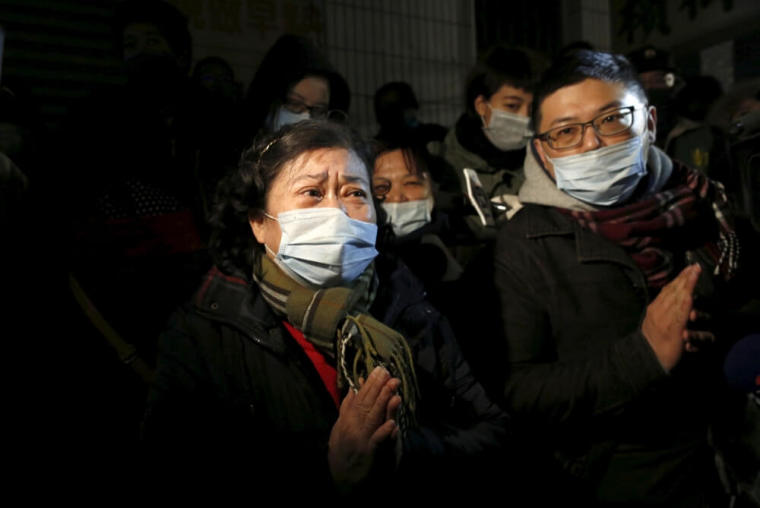 A woman prays for her relatives who were inside a 17-storey apartment building which collapsed after an earthquake hit Tainan, southern Taiwan, February 6, 2016.