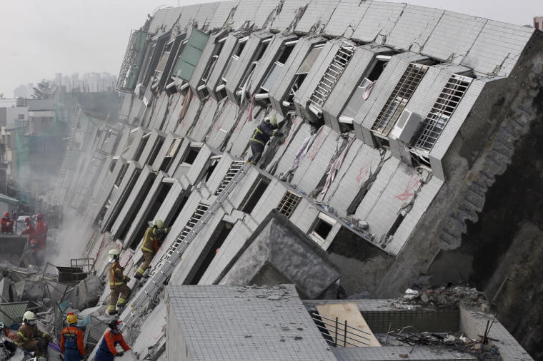 Rescue personnel work at the site where a 17-story apartment building collapsed during an earthquake in Tainan, southern Taiwan, February 6, 2016.