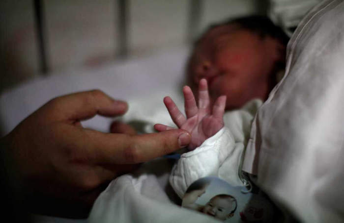 Chen Yiming touches the hand of his newborn baby at Ruijin Hospital in Shanghai October 24, 2011. Chen Yiming and his wife Yang Huiqing, both born under the one-child policy, had their first baby as the world population was about to reach the seven billion mark. China, the world's most populated country with more that 1.34 billion people, introduced a law that limits most urban families to one child. The policy is meant to avoid over-population, but as families shrink and the population structure moves towards an inverted pyramid, many demographers worry that a shrinking pool of young people won't be able to support and care for their elders. The United Nation projects the world's population will reach 7 billion on October 31, 2011. Picture taken on October 23, 2011.