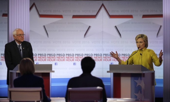 Democratic U.S. presidential candidate former Secretary of State Hillary Clinton speaks as Senator Bernie Sanders listens at the PBS NewsHour Democratic presidential candidates debate in Milwaukee, Wisconsin, February 11, 2016.