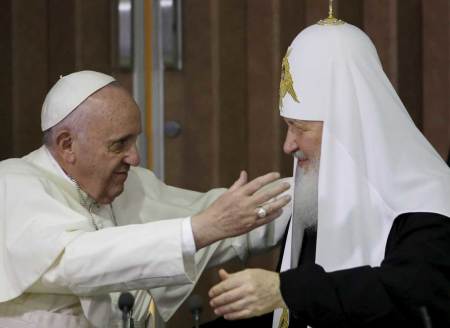 Pope Francis, left, reaches to embrace Russian Orthodox Patriarch Kirill after signing a joint declaration at the Jose Marti International airport in Havana, Cuba, Friday, February 12, 2016.