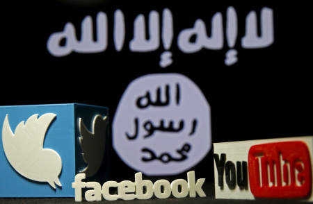 A 3D plastic representation of the Twitter and Youtube logo is seen in front of a displayed ISIS flag in this photo illustration in Zenica, Bosnia and Herzegovina, February 3, 2016. Iraq is trying to persuade satellite firms to halt Internet services in areas under Islamic State's rule, seeking to deal a major blow to the group's potent propaganda machine which relies heavily on social media to inspire its followers to wage jihad. Picture taken February 3, 2016.