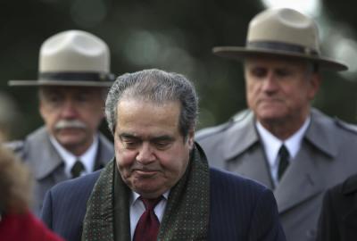 U.S. Supreme Court Justice Antonin Scalia (C) arrives at the Gettysburg National Cemetery in Pennsylvania November 19, 2013, the burial ground for Civil War Union soldiers in which U.S. President Abraham Lincoln travelled to in 1863 to deliver a few concluding remarks at a formal dedication. Today marks the 150th anniversary of Lincoln's famous two-minute speech, the Gettysburg Address.