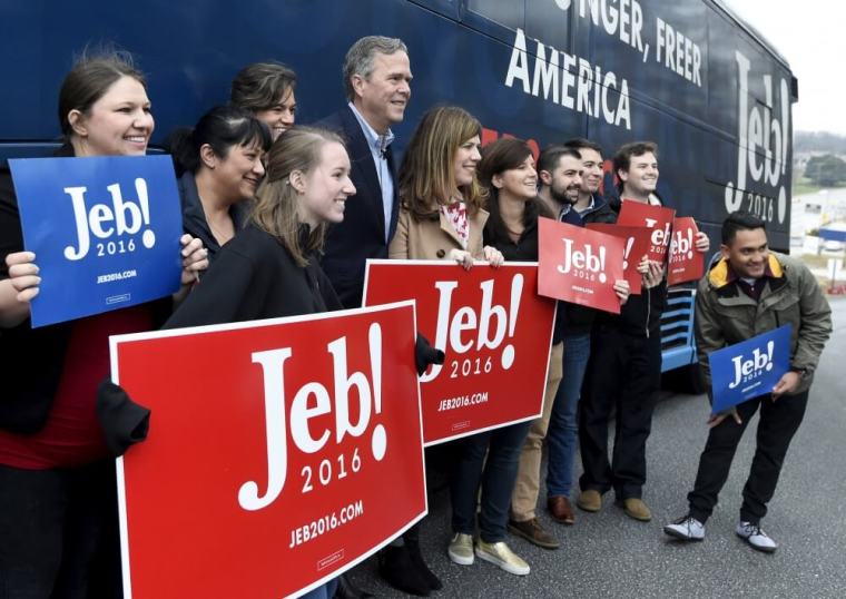 Republican U.S. presidential candidate Jeb Bush poses for pictures with supporters at a polling station in Greenville, South Carolina, February 20, 2016.