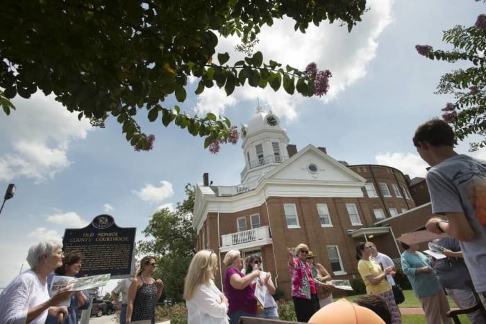 Nancy Anderson speaks to visitors about 'To Kill a Mockingbird' at the Monument to Atticus Finch near the Old Monroe County Courthouse while giving visitors a tour in Monroeville, Alabama July 14, 2015. The southern hometown of author Harper Lee is celebrating the release of 'Go Set a Watchman', Lee's first published novel in 55 years.