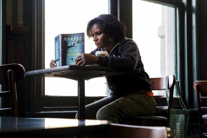 A customer reads a copy of Harper Lee's book 'Go Set a Watchman' after purchasing it at a Barnes & Noble store in New York, July 14, 2015. 'Go Set a Watchman,' the much-anticipated second novel by 'To Kill a Mockingbird' author Harper Lee, is the most pre-ordered print title on Amazon.com since the last book in the 'Harry Potter' series, Amazon said.