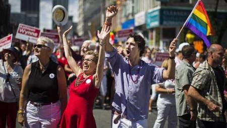 Liberal Party of Canada leader Justin Trudeau, Canada's first openly gay Ontario Premier Kathleen Wynne, and Wynne's partner Jane Rounthwaite (L) march during the gay pride parade in Toronto, June 30, 2013.