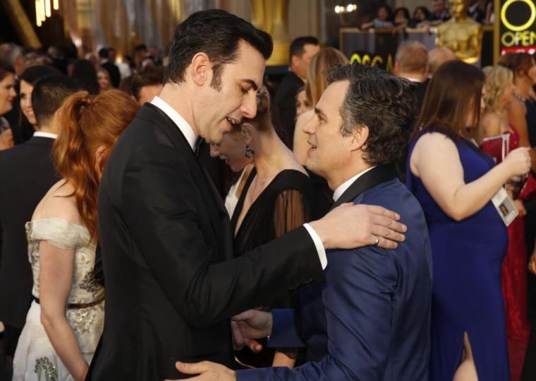 Presenter Sasha Baron Cohen talks with Mark Ruffalo (R), nominated for Best Supporting Actor for his role in 'Spotlight,' as they arrive at the 88th Academy Awards in Hollywood, California, February 28, 2016.