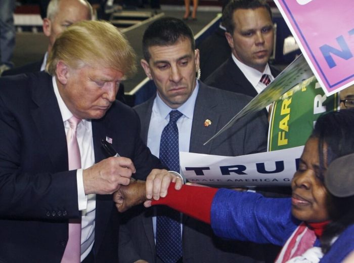 Republican U.S. presidential candidate Donald Trump autographs the back of a supporter's hand at a campaign rally at Valdosta State University in Valdosta, Georgia February 29, 2016.