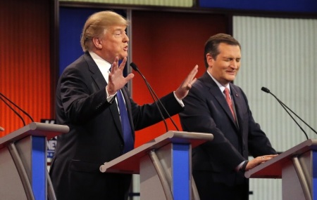 Republican U.S. presidential candidate Donald Trump speaks as rival candidate Ted Cruz (R) winces at the U.S. Republican presidential candidates debate in Detroit, Michigan, March 3, 2016.