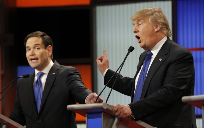 Republican U.S. presidential candidate Marco Rubio and rival candidate Donald Trump (R) speak simultaneously at the U.S. Republican presidential candidates debate in Detroit, Michigan, March 3, 2016.