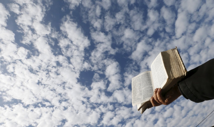 A demonstrator prays with the Bible outside of the congress during a rally against the draft law of the Chilean government which seeks to legalize abortion, in Valparaiso, August 4, 2015.