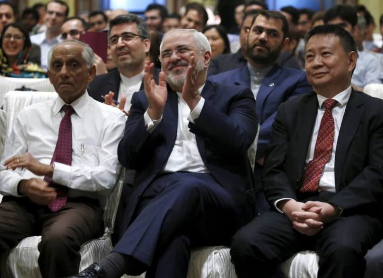 Iran's foreign minister Javad Zarif applauds at a public lecture 'Paradigm Shift from a Zero-Sum Game to a Win-Win Situation' in Singapore, March 8, 2016.