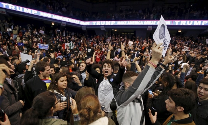 Demonstrators celebrate after Republican U.S. presidential candidate Donald Trump cancelled his rally at the University of Illinois in Chicago March 11, 2016.