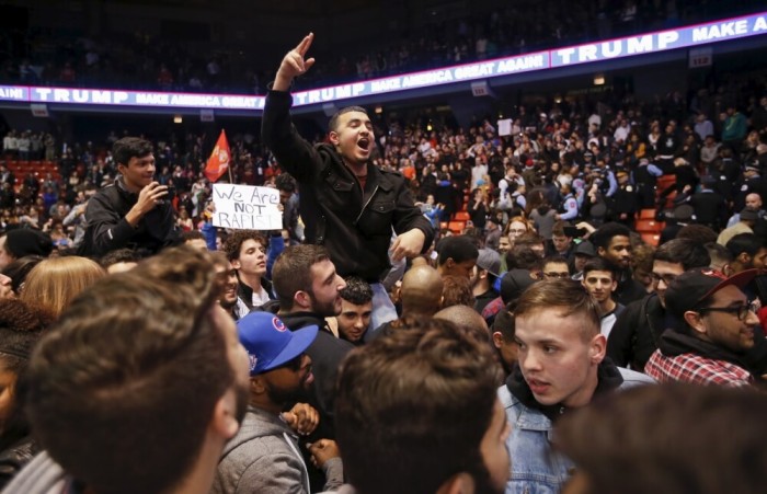 Demonstrators celebrate after Republican U.S. presidential candidate Donald Trump cancelled his rally at the University of Illinois at Chicago March 11, 2016.