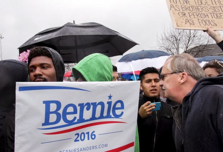 A supporter of U.S. Republican presidential candidate Donald Trump (R) confronts anti-Trump demonstrators outside a rally in Cincinnati, Ohio, March 13, 2016.