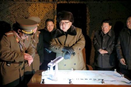 North Korea's leader, Kim Jong-un, center, at a rocket launch drill, in a photo released March 11.