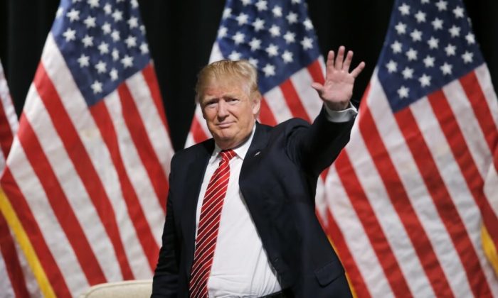 Republican U.S. presidential candidate Donald Trump acknowledges supporters at a town hall campaign event in Hickory, North Carolina, March 14, 2016.