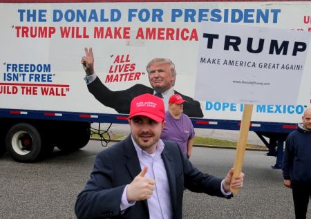 Bob Bolus, a supporter of U.S. Republican presidential candidate Donald Trump, gives the thumbs up to drivers as they pass by on Super Tuesday in Middleburg Heights, Ohio, March 15, 2016.