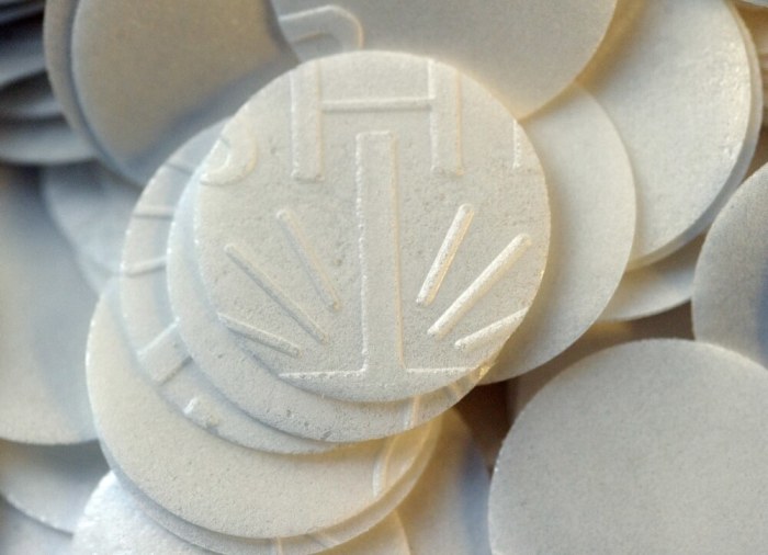 Low-gluten prayer breads fill a container at the Benedictine Sisters of Perpetual Adoration monastery in Clyde Missouri December 18, 2014. The Sisters have made communion wafers since 1910 and began making a low-gluten version in 2003 and have gone from 143 customers in 2004 to more than 11,000 customers from around the world.