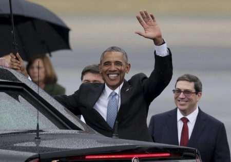 U.S. President Barack Obama waves while standing in front of Cuba's foreign minister Bruno Rodriguez (R) after he arrived at Havana's international airport for a three-day trip, in Havana, Cuba, March 20, 2016.