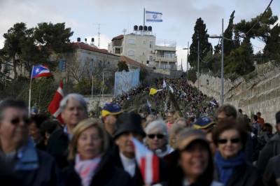 Credit : Catholic faithful hold palm fronds during a Palm Sunday procession on the Mount of Olives in Jerusalem, March 20, 2016.