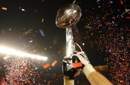 The Vince Lombardi Trophy is lifted into the air after the New Orleans Saints defeated the Indianapolis Colts in the NFL's Super Bowl XLIV football game in Miami, Florida, February 7, 2010.