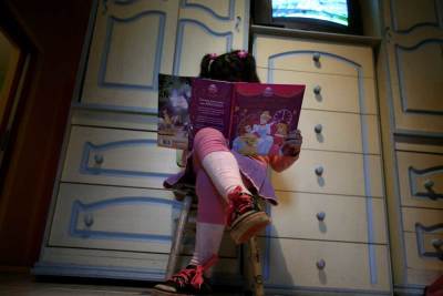 Lulu, a transgender girl, reads a book in her room at her home in Buenos Aires July 25, 2013. 