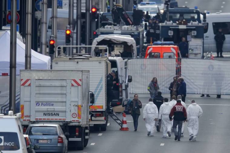 Forensics experts arrive at the Maalbeek metro station following an explosion in Brussels, Belgium, March 22, 2016.