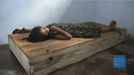 A mentally ill woman is chained to a wooden crate in Indonesia in this undated photo.