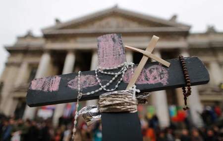 A cross is seen in front of the old stock exchange building at a street memorial to victims of Tuesday's bombings in Brussels, Belgium, March 24, 2016.