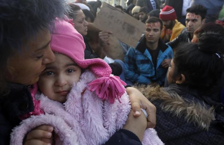 Stranded Iranian migrants are seen on rail tracks during a protest at the Greek-Macedonian border near the Greek village of Idomeni, Greece, November 26, 2015. Countries along the Balkan route taken by hundreds of thousands of migrants seeking refuge in western Europe last week began filtering the flow, granting passage only to those fleeing conflict in Syria, Iraq and Afghanistan.