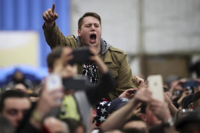 A man reacts as U.S. Republican presidential candidate Trump speaks on stage during a campaign event at Grumman Studios in Bethpage, New York April 6, 2016