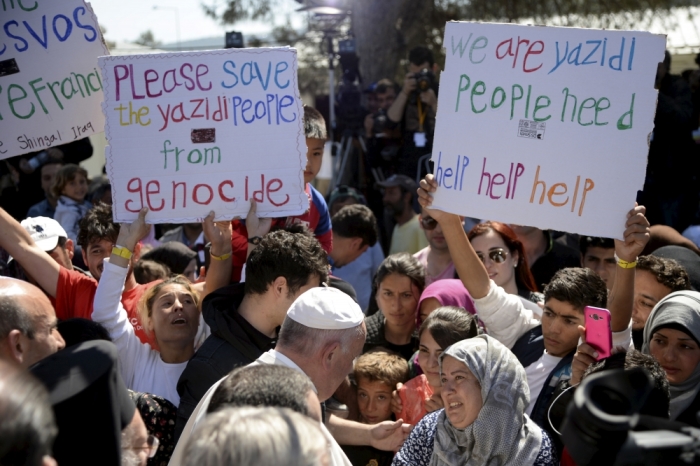 Pope Francis greets migrants and refugees at the Moria refugee camp near the port of Mytilene, on the Greek island of Lesbos, Greece, April 16, 2016.