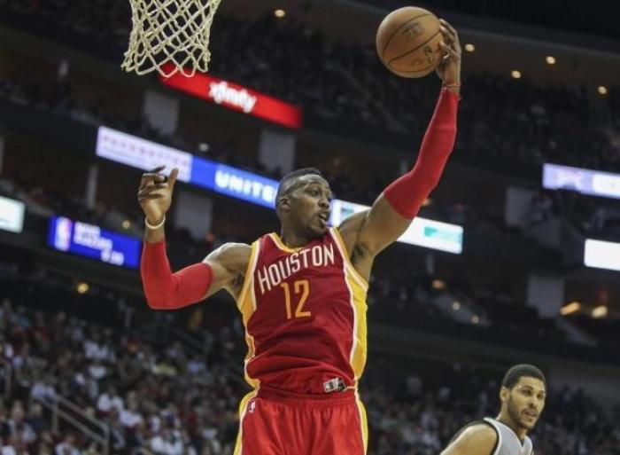 Nov 6, 2014; Houston, TX, USA; Houston Rockets center Dwight Howard (12) gets a rebound during the second quarter against the San Antonio Spurs at Toyota Center. In recent news, Howard is reportedly leaving the Rockets and heading for the Bulls.