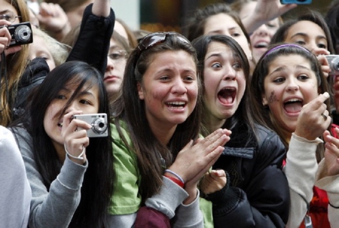 A group of teenage girls screaming.