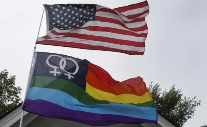 A Gay Pride flag flies below the U.S. flag during a celebration of the U.S. Supreme Court's landmark ruling of legalizing gay marriage, January 8, 2016