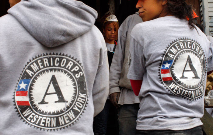 Americorps workers take a break from gutting a house being renovated into affordable housing by PUSH, a non-profit organization working to rebuild the West Side of Buffalo, New York November 19, 2009. Buffalo has 15,000 vacant lots from houses that have been demolished, amounting to 3200 acres of vacant land.