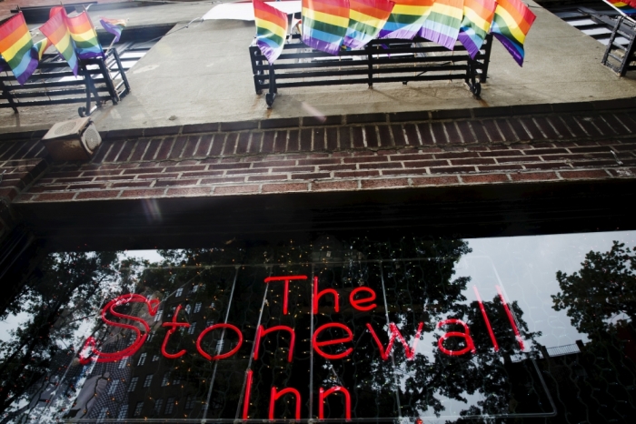 A neon sign shines in the window of the Stonewall Inn in New York, June 23, 2015. The New York City bar that grew into a cultural icon due to its pivotal role in the birth of the gay rights movement, the Stonewall Inn, was granted the historic status of landmark by city officials on Tuesday.