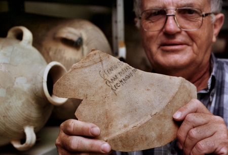 Israeli archaeologist Prof. Ehud Netzer displays the shard from a 2,000-year-old amphora bearing the name of 'Herod the Great, King of Judea' July 9. The unique ceramic shard, found during a recent archaeological dig on the ancient desert fortress of Masada, came from a large amphora used for shipping Italian wine to the king who ruled the holy land at the time of Jesus' birth.