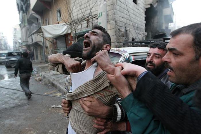 A father learns of the deaths of two of his children in Aleppo in this undated photo.