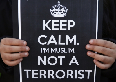 A girl holds a sign during a rally by members of the Muslim community of Madrid outside Madrid's Atocha train station, January 11, 2015, in solidarity with the victims of a shooting by gunmen at the Paris offices of the satirical weekly newspaper Charlie Hebdo, and against Islamophobia.