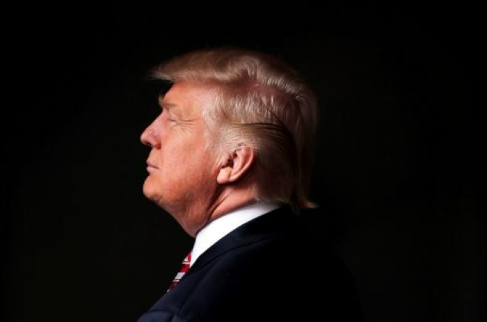 Republican U.S. presidential candidate Donald Trump poses for a photo after an interview with Reuters in his office in Trump Tower, May 18, 2016