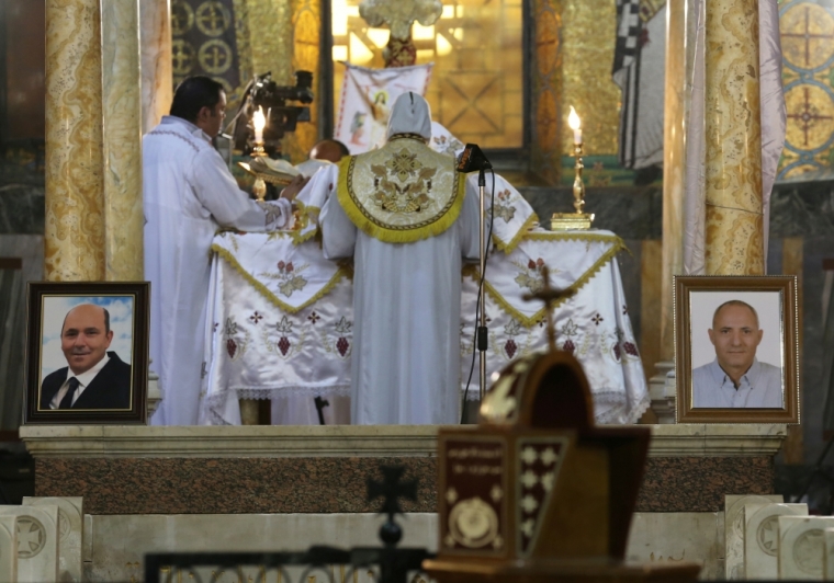 A picture of Medhat Michel, on the left, and a picture of Waguih Mourise, two of the Christian victims of the crashed EgyptAir flight MS804, are seen during an absentee funeral mass at the main Cathedral in Cairo, Egypt, May 22, 2016.