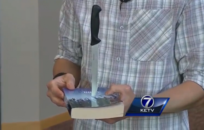 Youth pastor, Mic Henton, of College View Seventh-day Adventist Church in Lincoln, Nebraska shows the Bible stabbed by unknown individuals.