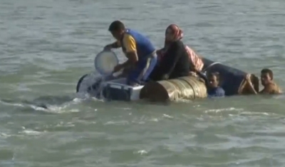 A still image from video released June 6, 2016 shows Iraqi families attempting to escape the besieged city of Falluja, Iraq, by crossing the Euphrates river, June 3, 2016.