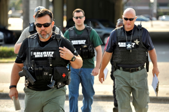 Officers arrive at the Orlando Police Headquarters during the investigation of a shooting at the Pulse nightclub, in Orlando, Florida, June 12, 2016.