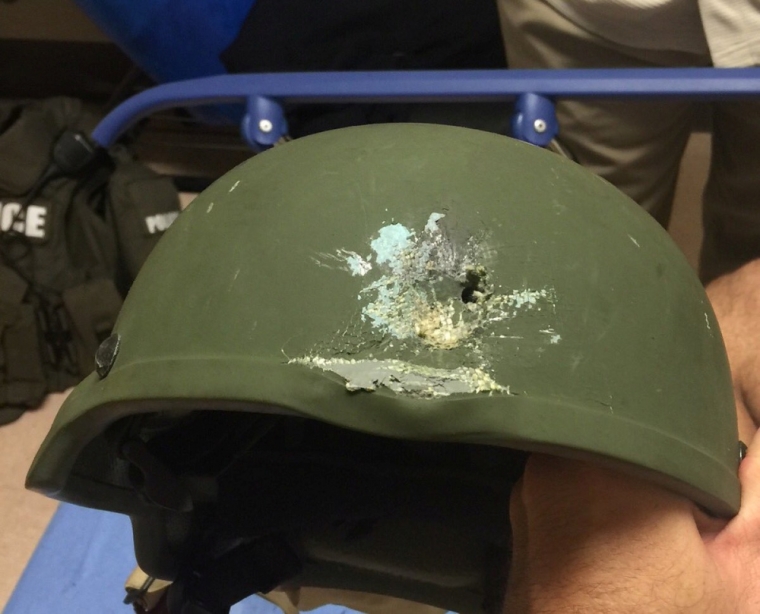 A handout photograph posted by the Orlando Police Department on Twitter with the words, 'Pulse shooting: In hail of gunfire in which suspect was killed, OPD officer was hit. Kevlar helmet saved his life', in reference to the operation against a gun man inside Pulse night club in Orlando, Florida, June 12, 2016.